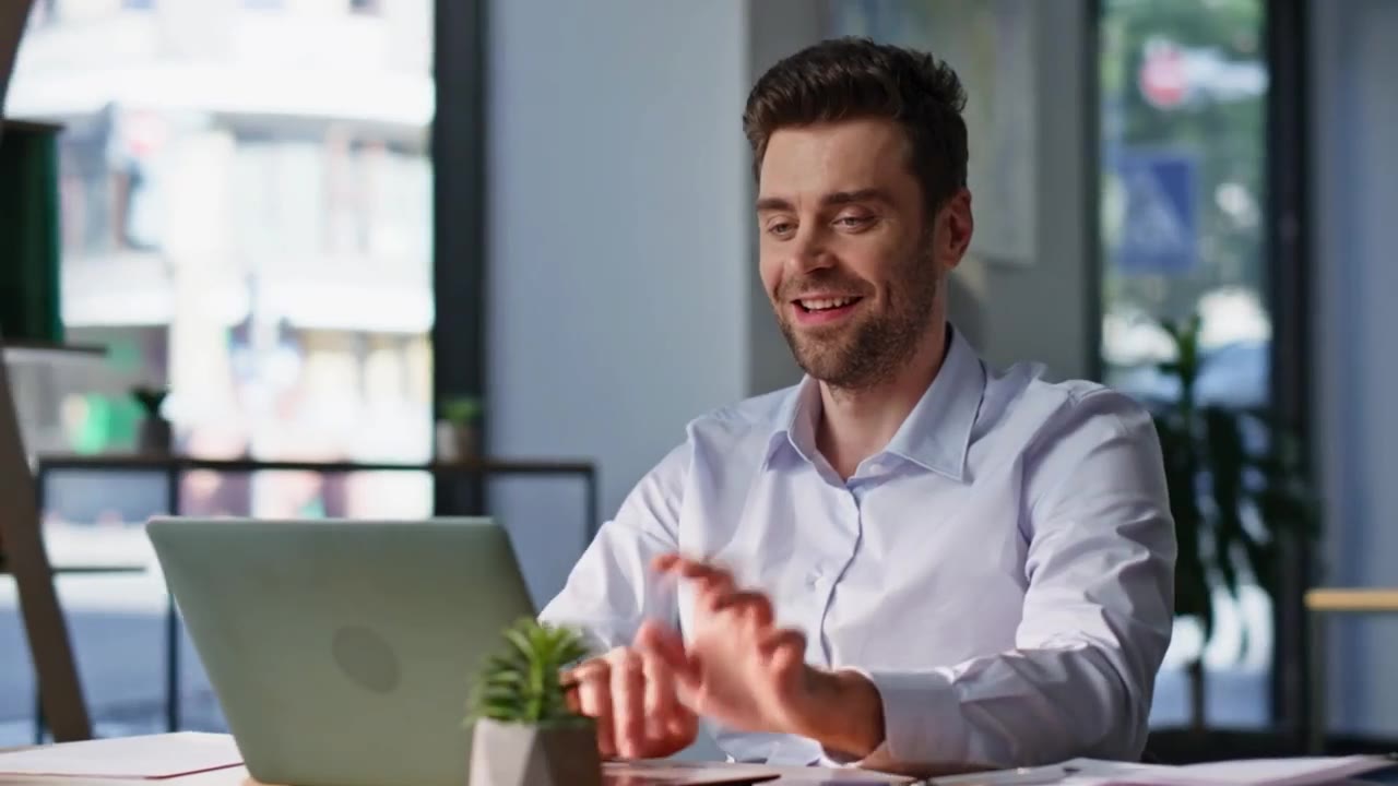 A treasurer at his desk, laptop open, mid-conversation
